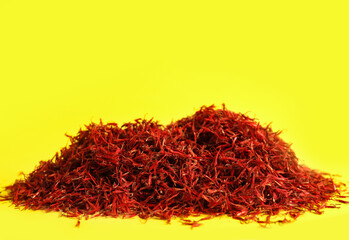 Pile of saffron on yellow background