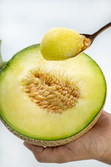 Golden spoon with Crown Musk Melon on white background, Shizuoka Crown Melon Yama Grade on isolate on white background.