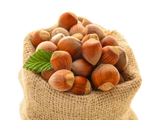 Sack bag with shelled hazelnuts on white background