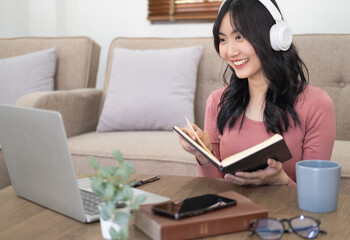 Smiling girl student wear wireless headphone study online with skype teacher, happy young woman...