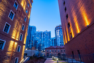 Illuminated high brick wall of an old building.