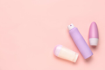 Different deodorant bottles on pink background