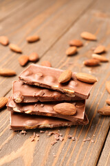 Sweet tasty chocolate with nuts on  wooden background