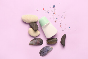 Obraz na płótnie Canvas Deodorant with shells, stones and sea salt on pink background