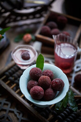 Red bayberry on the table(waxberry), in a building interior with oriental charm, dark environment, dark tone picture