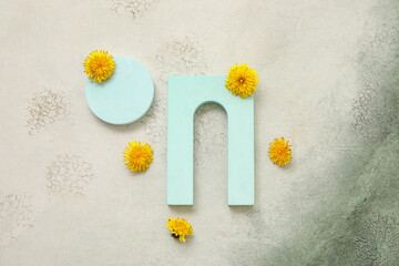 Obraz premium Decorative podiums with dandelion flowers on grey grunge background
