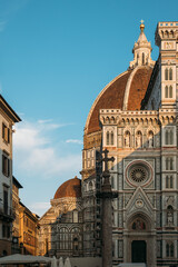Fototapeta na wymiar Historical landmark of Italy is the amazing Florence Cathedral of St. Mary of the Flower with a complex ornament and composition on a sunny summer evening. Concept of medieval architecture in Europe
