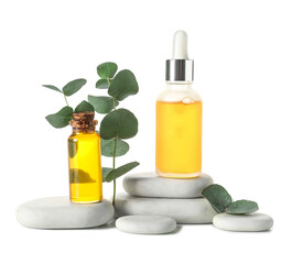 Bottles with cosmetic oil, eucalyptus branch and stones on white background