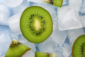 Sliced fresh kiwi and ice cubes on blue background