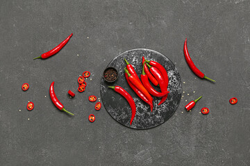 Slate board with fresh chili peppers on dark background - obrazy, fototapety, plakaty