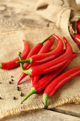Heap of fresh chili peppers on wooden background
