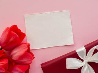 Tulips flowers, wallet with a bow and paper background with copy space
