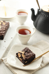 Homemade Dark Chocolate Brownies Topping with Almonds Slices and Chocolate Chips.