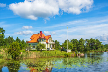Summer idyll with a house on a hill by a beautiful lake