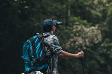 Fototapeta premium Hikers use binocular to see animals and view landscape with backpacks in the forest. hiking and adventure concept.