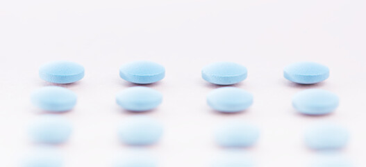 Pharmaceutical medicine pills, tablets and capsules laid out in a grid on bright light pink background . Medicine concepts.