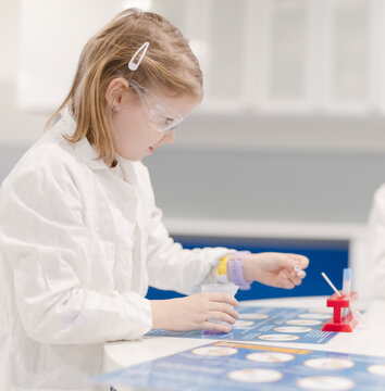 Young student works girl in laboratory