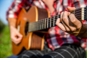 Guitars acoustic. Male musician playing guitar, music instrument. Man's hands playing acoustic...