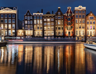 Obraz premium Dancing Houses Damrak Amsterdam during the evening lights Netherlands.