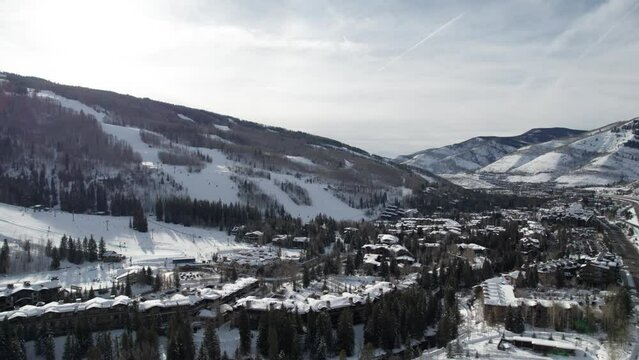Panning drone shot of a busy ski resort in Colorado, United States