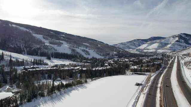 Drone shot of a busy highway and a ski resort in Colorado