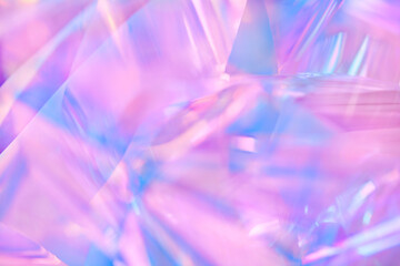 Close-up of ethereal pastel neon pink, purple, lavender, mint holographic metallic foil background....