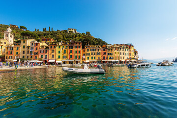 Obraz na płótnie Canvas Port of the famous village of Portofino, luxury tourist resort in Genoa Province, Liguria, Italy, Europe. Colorful houses, Mediterranean sea (Ligurian sea).