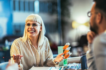  Creative young businesswoman sharing her ideas during a meeting in a modern office.
