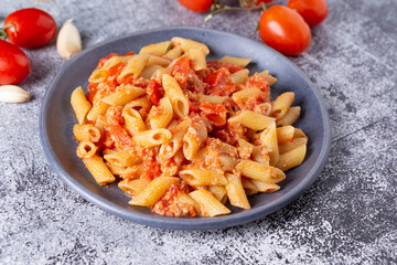 Pennette with tuna and cherry tomatoes. Typical dish of traditional Italian and Mediterranean cuisine. Healthy and balanced dish suitable for both lunch and dinner.