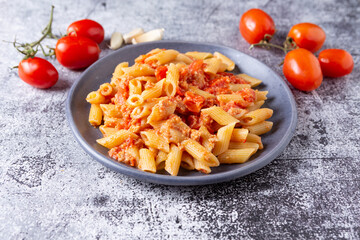 Pennette with tuna and cherry tomatoes. Typical dish of traditional Italian and Mediterranean cuisine. Healthy and balanced dish suitable for both lunch and dinner.