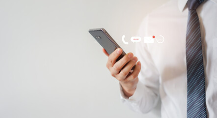 close up businessman hand use smartphone and try to communicate with operator company to request assistance or revise information and with virtual icon for contact us support service concept