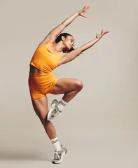 Fotobehang Flexible female athlete displaying impressive balance and agility in a gymnastic workout pose © Jacob Lund