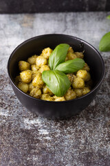 potato gnocchi with homemade basil pesto. Typical dish of traditional Italian cuisine, suitable for those who follow a vegetarian diet.