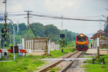 Perspective view of the train is departing from the Wat Chang Hai station, Pattani, South of Thailand. Diesel electric locomotive of State Railway of Thailand