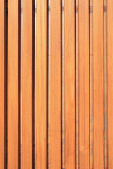 Wooden wall made of slats. Thin boards. The texture of the boards. Wooden background.