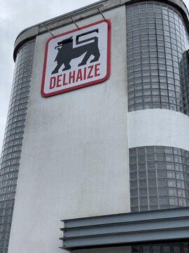 Brussels, Belgium - February 21, 2022: Delhaize supermarket chain exterior. Delhaize Group SA was a Belgian multinational retail company since 2015 Ahold Delhaize, new parent holding company