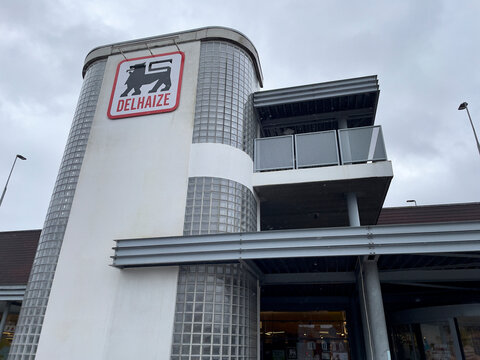 Brussels, Belgium - February 21, 2022: Delhaize supermarket chain exterior. Delhaize Group SA was a Belgian multinational retail company since 2015 Ahold Delhaize, new parent holding company