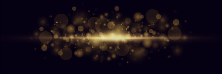 Glittering magic dust and bokeh golden particles on a black background. Glitter and elegance for Christmas.