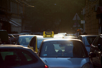 Taxi on a street full of cars