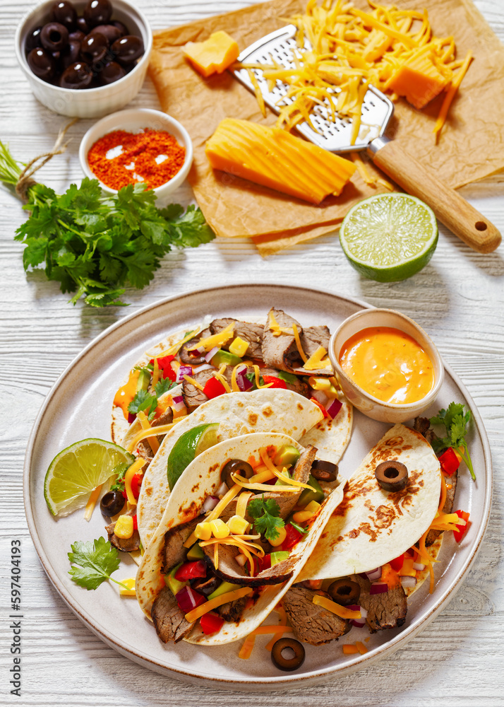 Sticker beef steak tacos with veggies, avocado, corn