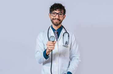 Young doctor holding blood pressure monitor. Handsome doctor showing blood pressure monitor isolated