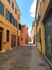 Fototapeta na wymiar Empty street in Ferrara, Italy. Vertical panorama of the street.