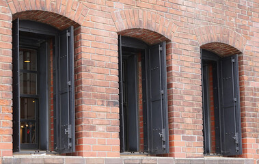Old building with brick walls with three windows