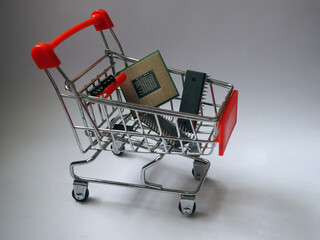 Chip market and trading concept. Shopping cart with chips, CPU and integrated circuits....