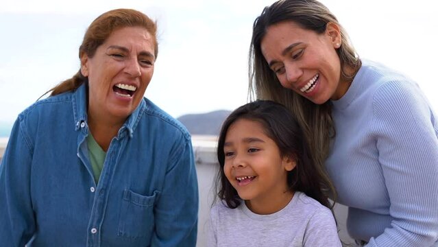 Happy multigenerational latin family having fun together in front of camera - Grandmother, daughter and granddaughter love concept
