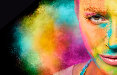 Mysterious young woman covered in rainbow colored powder with a color explosion in the background....