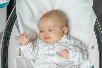 Cute baby is sleeping in bedroom. Concept of newborn, family and love