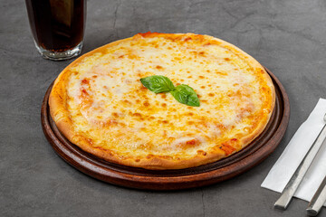 Italian pizza with four cheeses and lots of mozzarella on a cutting board