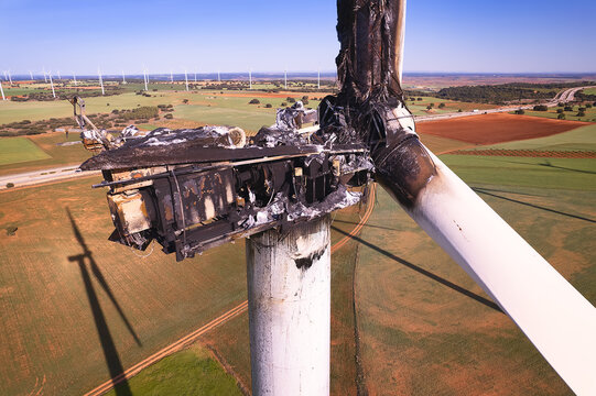 View from Above of the Striking Panorama of a Burned-Out Wind Turbine in a wind farm. Close-up on wind turbine destroyed by fire after a lightning strike. Windmill over heated and set fire. Spain