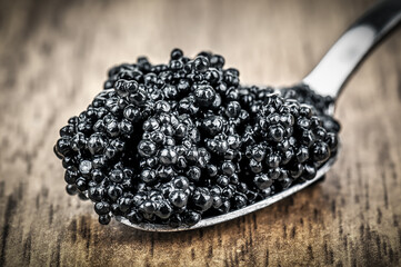 Delicious black caviar on silver spoon
